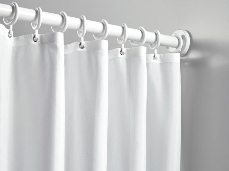 Shower curtain with rings attached to a shower rail